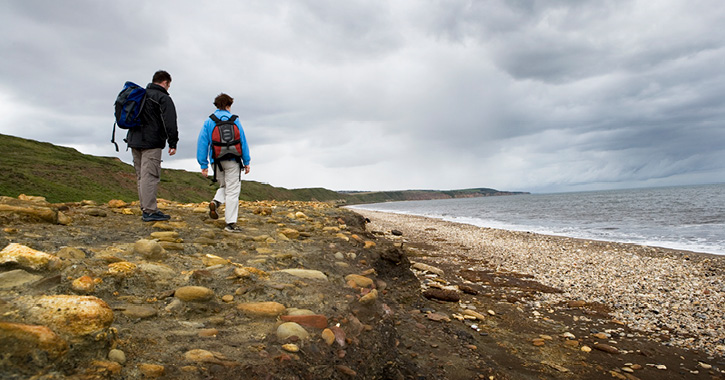 couple walking on Horden Beach, County Durham.